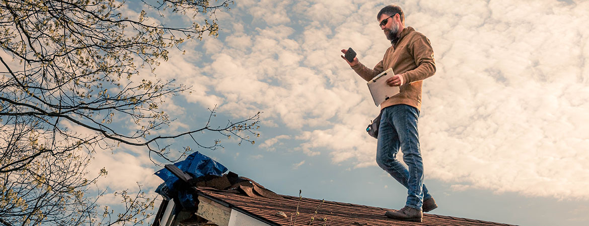 Matthew Carrico, a Senior Property Claim Adjuster for Kentucky Farm Bureau Insurance, inspects a property in Shelby County, Ky.