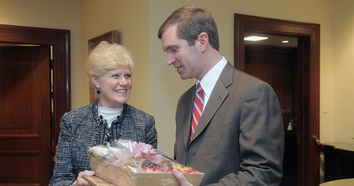 KFB Women's Advisory Committee Chair Judy Hayden gives Kentucky Governor Andy Beshear a basket of Kentucky Proud agriculture products during KFB Legislative Drive-In and Food Check-Out Day KFB Women's Advisory Committee Chair Judy Hayden gives Kentucky Governor Andy Beshear a basket of Kentucky Proud agriculture products during KFB Legislative Drive-In and Food Check-Out Day