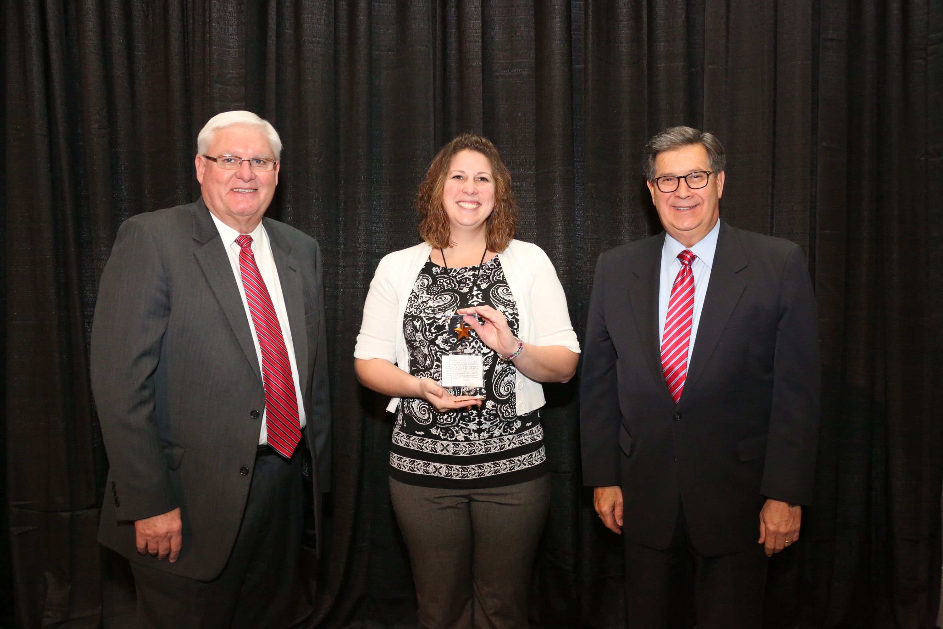 Michelle Simon of Scott County accepts the Gold Star Award of Excellence from Mark Haney, Kentucky Farm Bureau President, and David S. Beck, Kentucky Farm Bureau Executive Vice President. Michelle Simon of Scott County accepts the Gold Star Award of Excellence from Mark Haney, Kentucky Farm Bureau President, and David S. Beck, Kentucky Farm Bureau Executive Vice President.