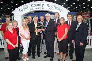 Taylor County won the Pride of the Counties top exhibit award. Here, KFB President Mark Haney presents an award to Taylor County Judge-Executive Eddie Rogers. KFB First Vice President Eddie Melton is behind them and to the right are KFB Insurance Company Executive VP Brad Smith, KFB Federation Executive VP David S. Beck and 2nd VP Fritz Giesecke. The lady at right is Sherry Kerr, Occupational Tax Clerk for Taylor County. Front row from the left are Debbie McNear, Executive Secretary to the county judge-executive; County Treasurer Melissa Williams and Alisha Nelson, Executive Director of Taylor County tourism. Back row from left are Tony Smith, the county government’s information technology specialist; and magistrates John Gaines and Dr. James Jones.