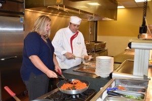 Amanda Langlitz assists sous chef Darwin Gross in preparing a lunch at Transylvania University.