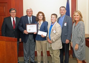 Robin Mason, owner of Pumpkin Vine Creek LLC and creator of Woven Compost, receives a $10,000 check for her semi-finalist finish in the AFBF Rural Entrepreneurship Challenge. Pictured left to right are: David S. Beck, Executive Vice President of KFB Federation; Mark Haney, KFB President; Robin Mason and her son, Andrew; Robert Anderson of Central Kentucky Ag Credit; and Lindsey Bridges of Farm Credit Mid-America.